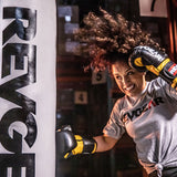 Fighter striking a heavy bag in a gym